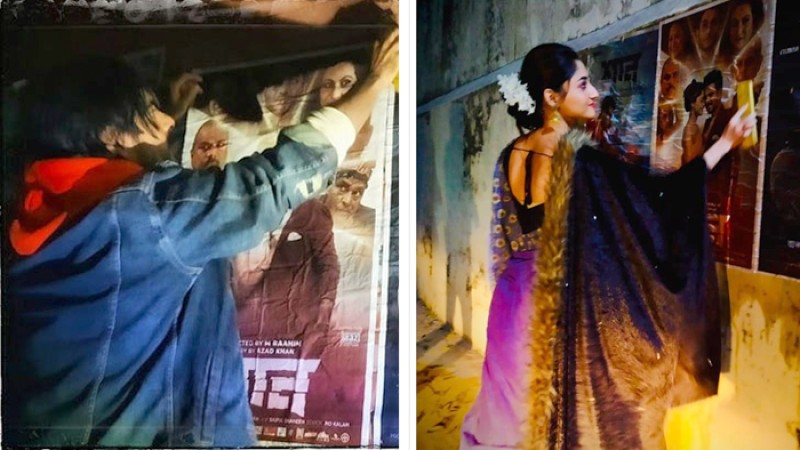 দেয়ালে দেয়ালে সিনেমার পোস্টার লাগাচ্ছেন সিয়াম-পূজা